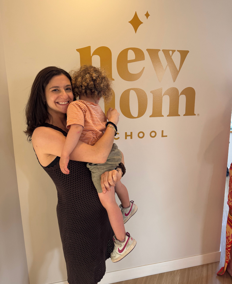 Eva Almiñana, owner of New Mom School Philadelphia, holding her child in the Rittenhouse studio